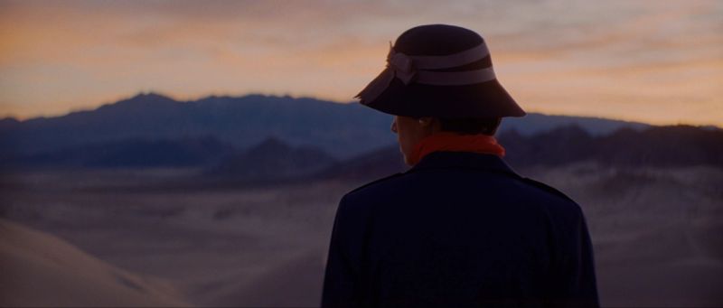 Cinematographer Ian Rigby captures a lone figure in hat and coat against desert mountains at dusk.