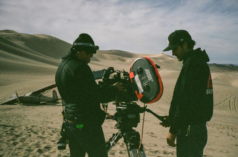 Cinematographer and camera operator filming on sand dunes with ARRI camera
