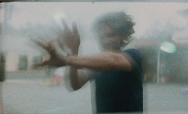 Cinematographer Ian Rigby's hands pressed against a foggy, misty window.