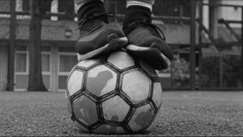 Close-up of feet in Nike cleats balancing on a soccer ball.