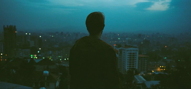 Silhouette of director Vincent Urban overlooking Ethiopian cityscape at dusk