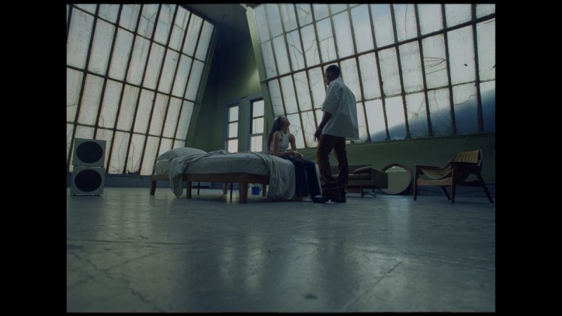 Giveon and a woman in a minimalist room with large windows and film photography
