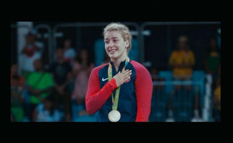 Olympic wrestler Helen Maroulis smiles with a gold medal around her neck.