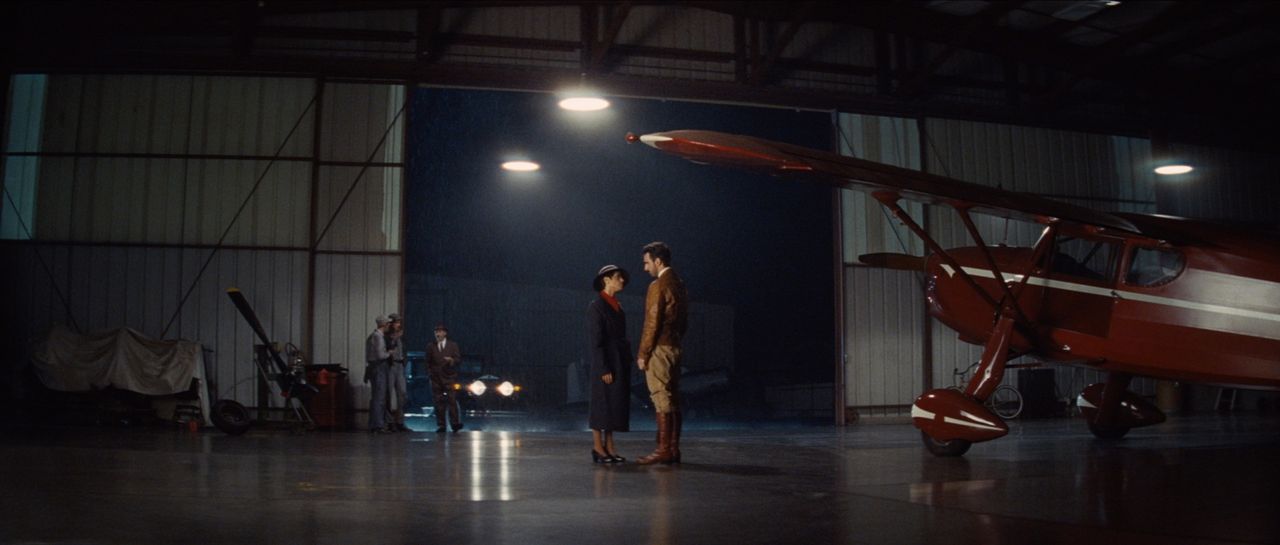 Cinematographer Ian Rigby captures a dramatic night scene in an aircraft hangar with vintage plane and film lighting.