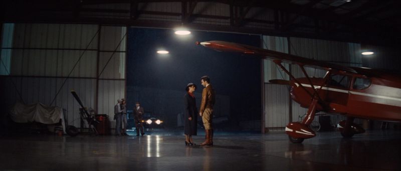 Cinematographer Ian Rigby captures a dramatic night scene in an aircraft hangar with vintage plane and film lighting.