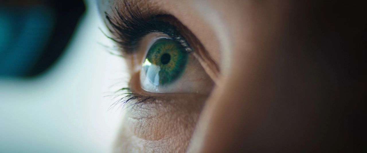 Extreme close-up of a green eye with long lashes, cinematic detail from Jaguar Rogue Moments.