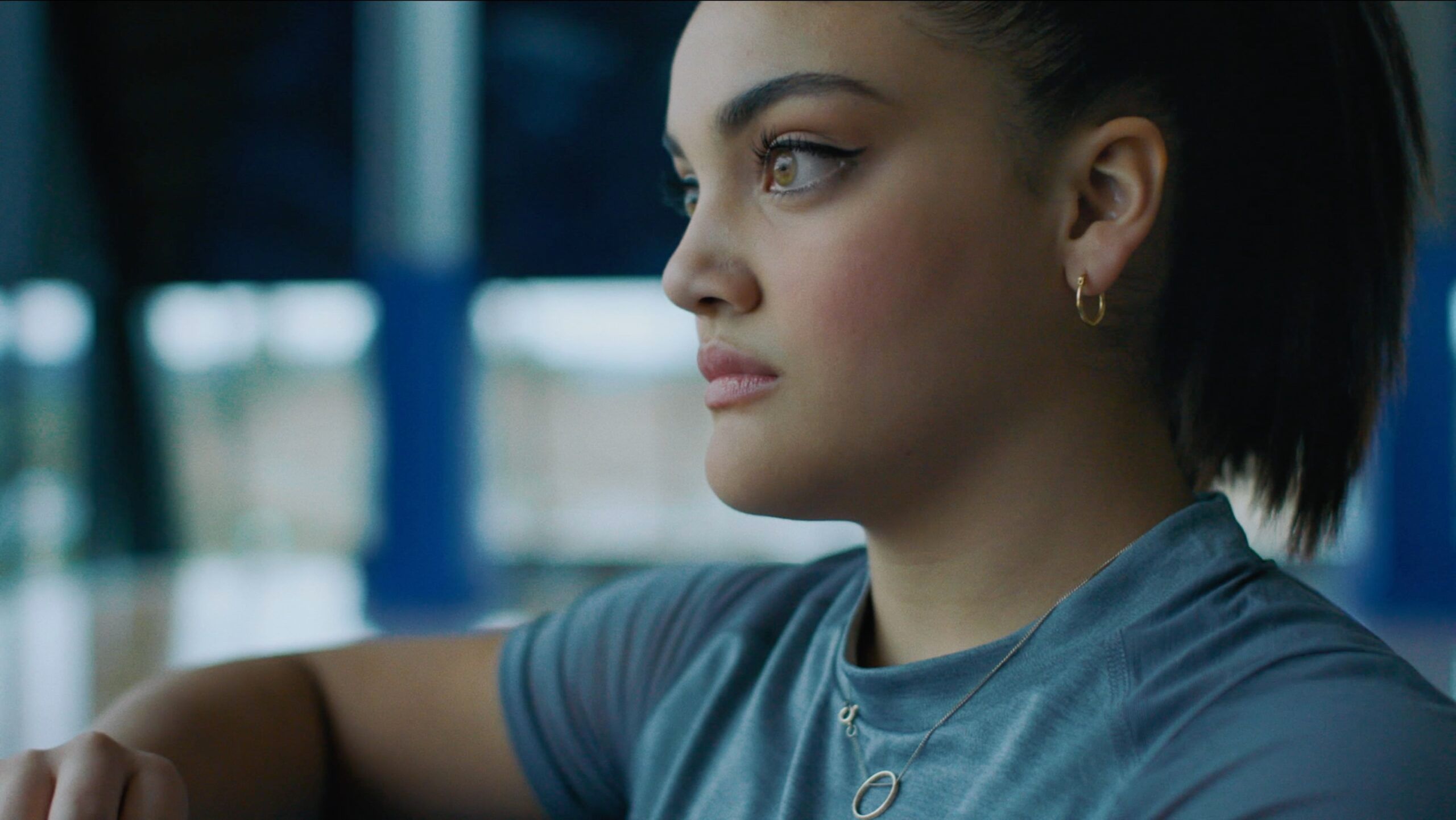 Young woman in blue shirt gazing thoughtfully, Nike Dear Nike project still