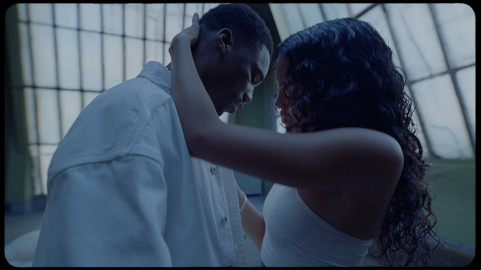 Intimate close-up of a couple embracing in soft, cinematic lighting