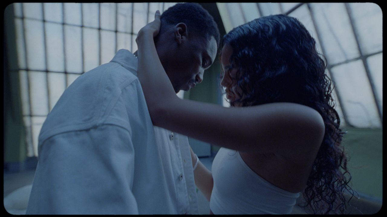 Intimate close-up of a couple embracing in soft, cinematic lighting