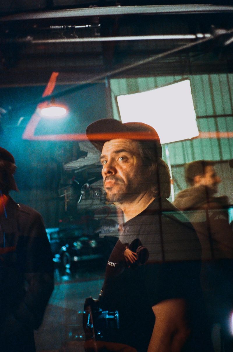 Ian Rigby on film set with camera, reflecting cinematic lighting and production atmosphere.