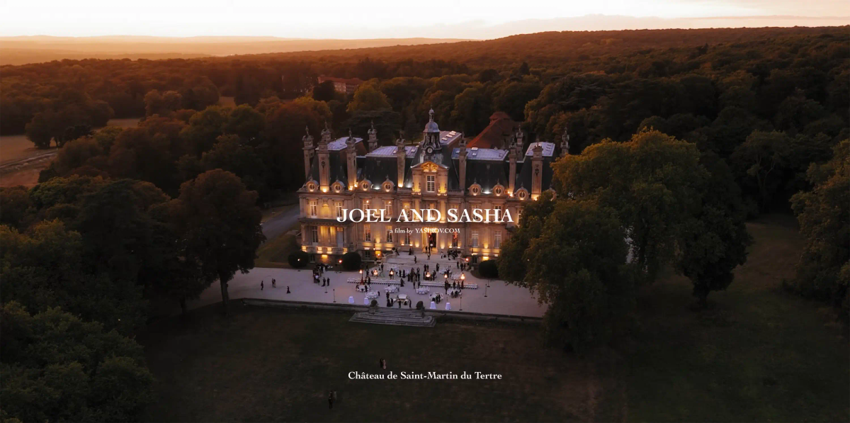 Château de Saint-Martin du Tertre lit at dusk, seen from above across its private park near Paris, France