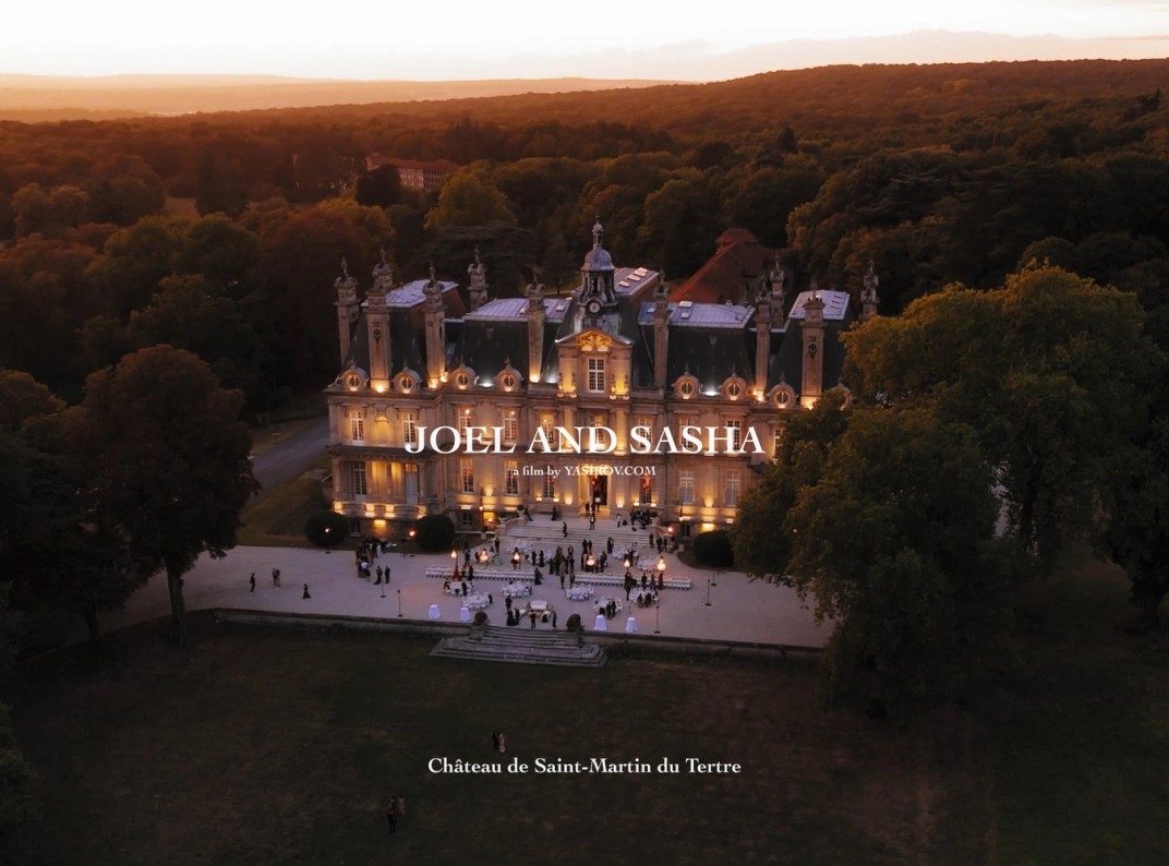 Château de Saint-Martin du Tertre lit at dusk, seen from above across its private park near Paris, France