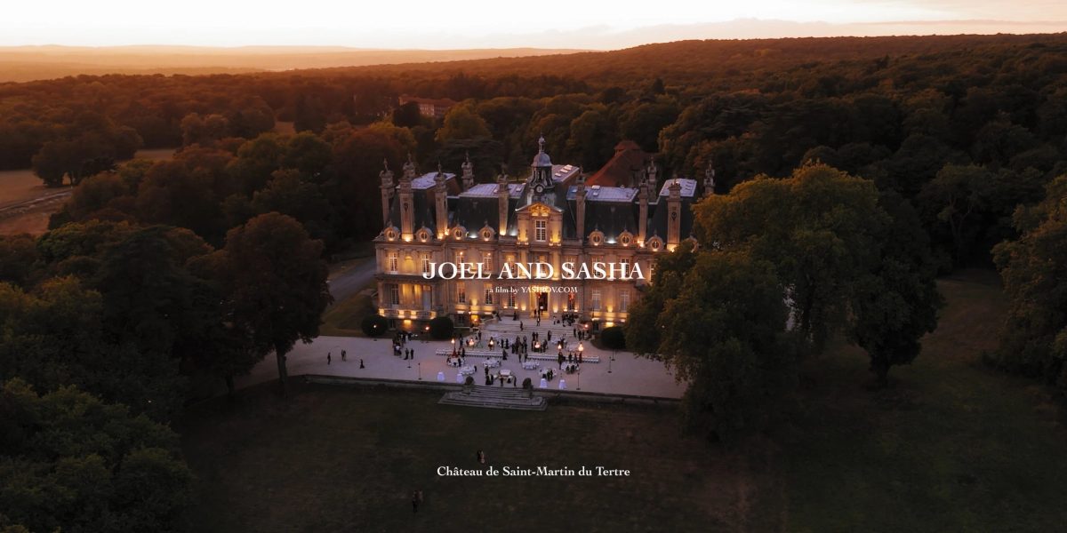 Château de Saint-Martin du Tertre lit at dusk, seen from above across its private park near Paris, France