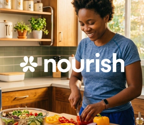 A woman smiling while prepping fresh vegetables in her kitchen, overlaid with the 'Nourish' brand name and logo.