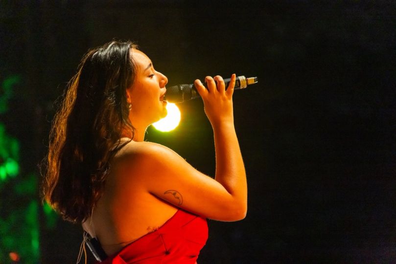 Singer backlit in red
