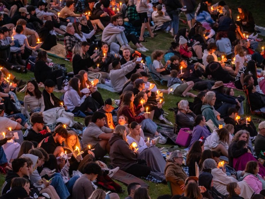 Families with candles on the hillside