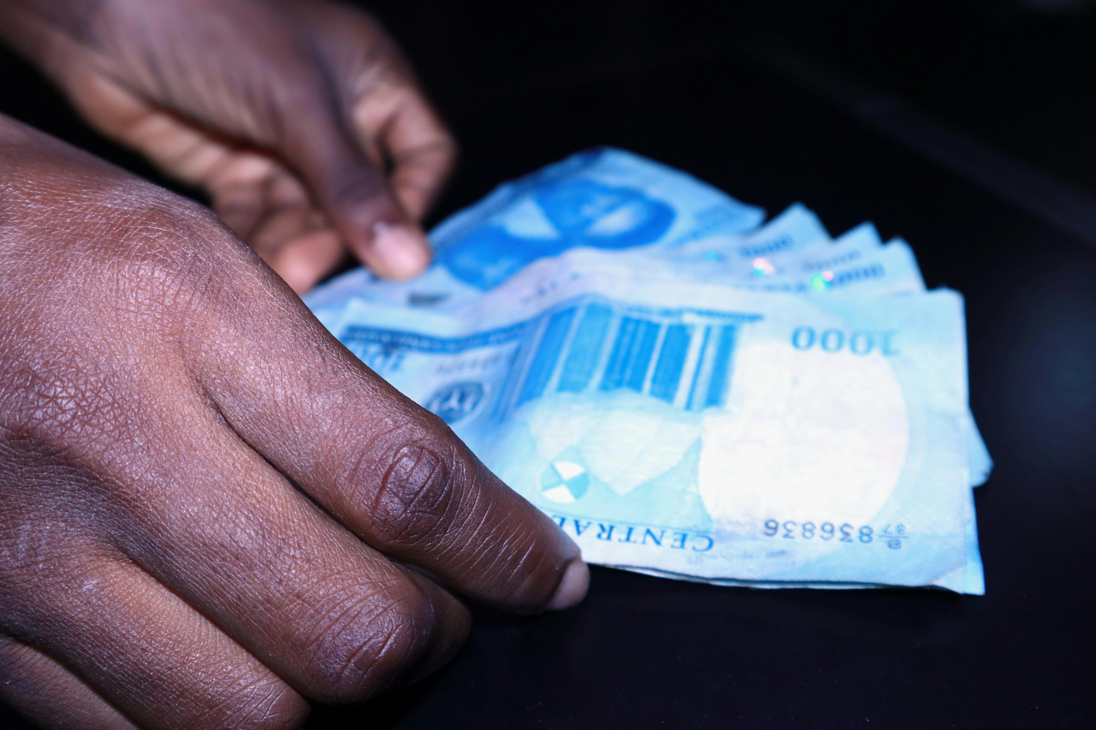 Hands Holding Nigerian Naira