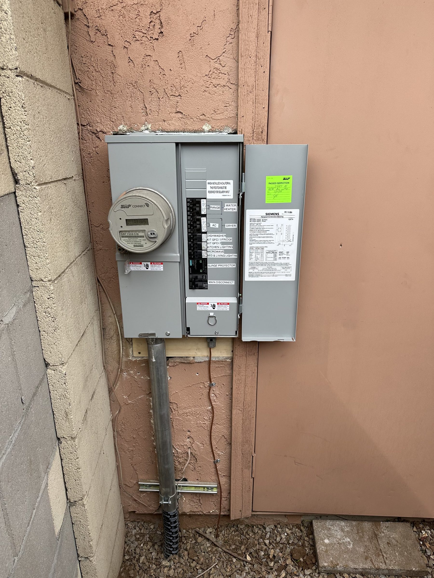 New Siemens meter-main combo with an inspection tag on a stucco wall