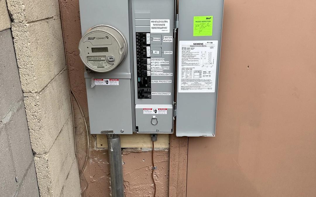 New Siemens meter-main combo with an inspection tag on a stucco wall