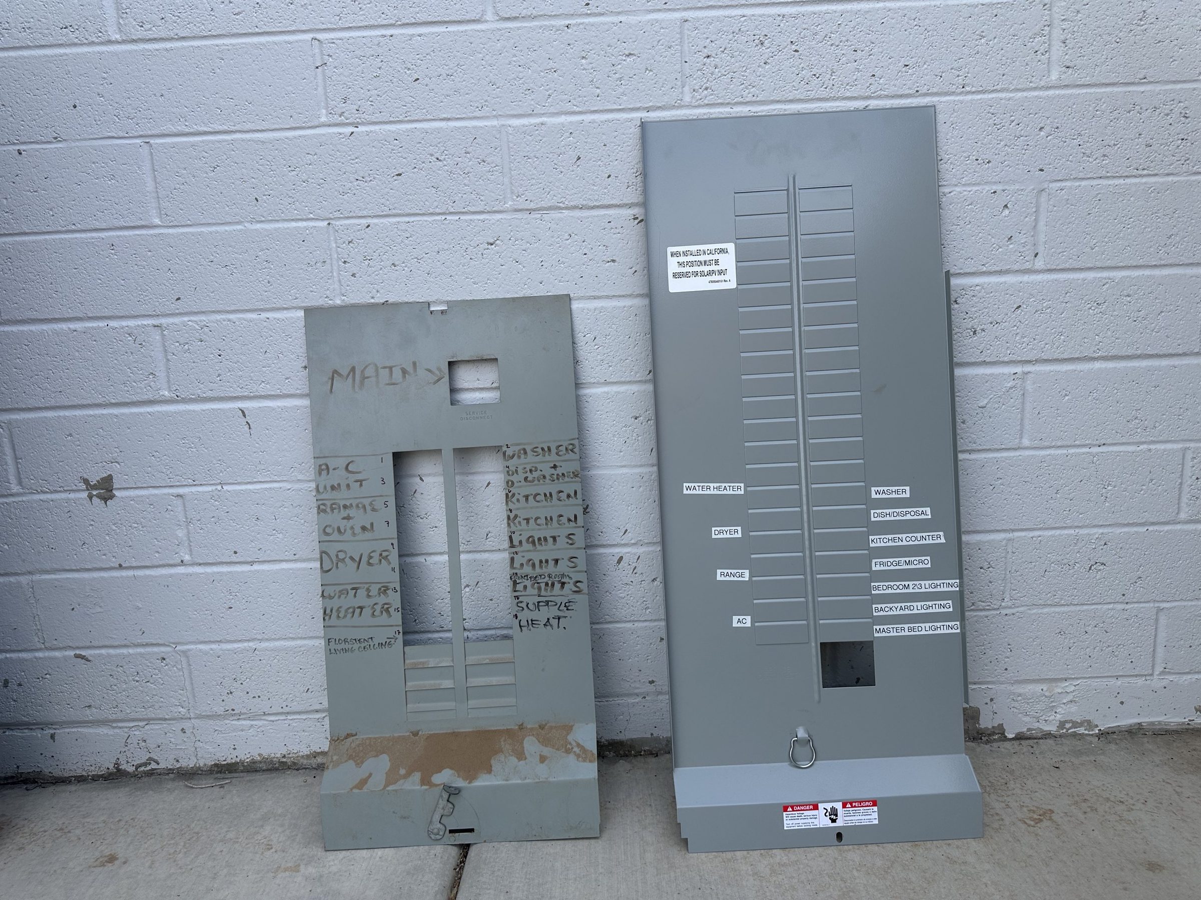 Old panel cover with handwritten labels beside a new cover with printed circuit labels
