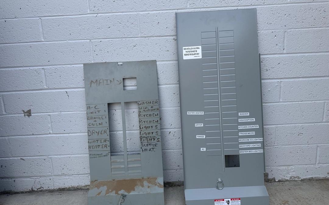 Old panel cover with handwritten labels beside a new cover with printed circuit labels
