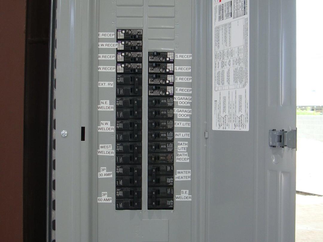 New breaker panel with neatly printed circuit labels including welder circuits
