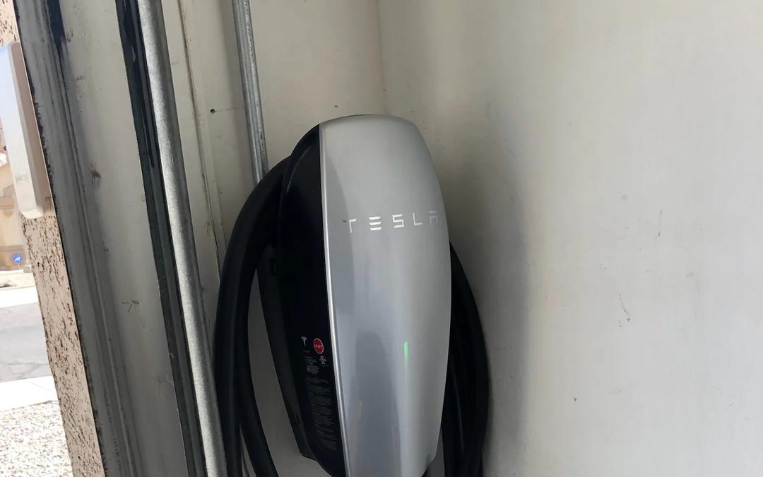 A Tesla Wall Connector installed on a garage wall