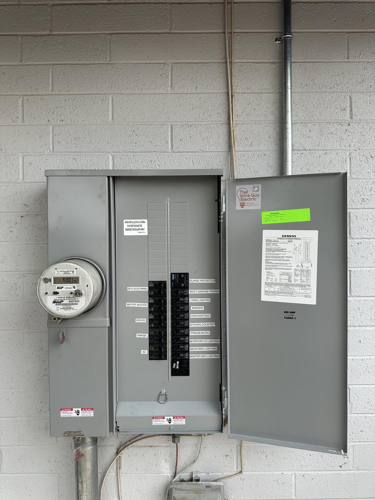 New Siemens meter-main panel with printed labels and a Wire Guy Electric sticker on the door