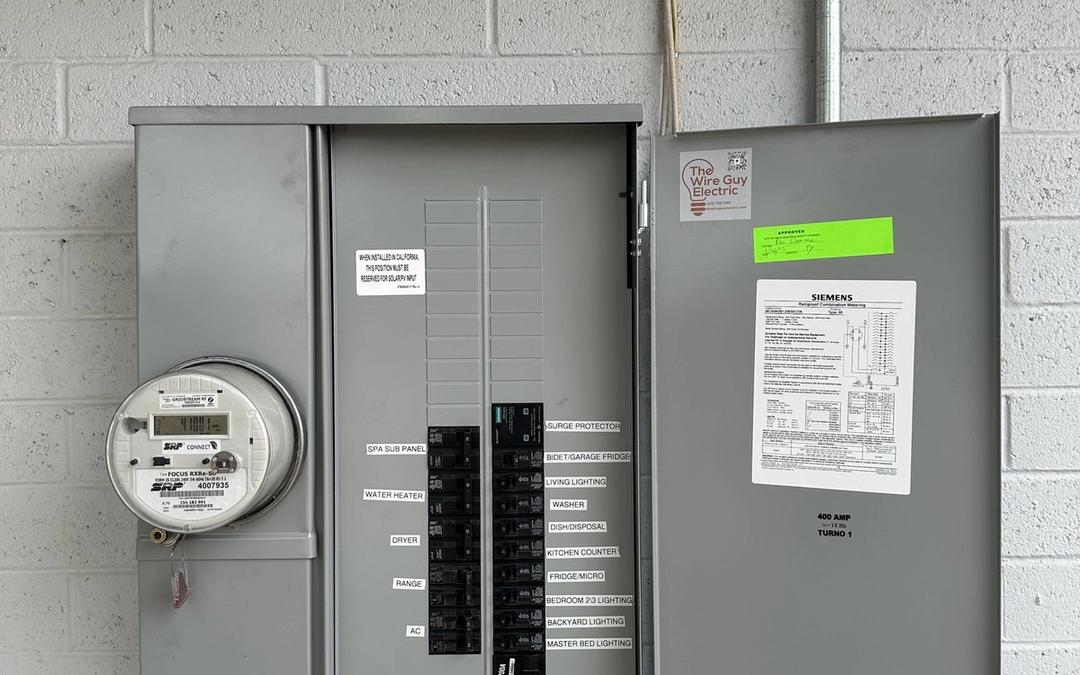 New Siemens meter-main panel with printed labels and a Wire Guy Electric sticker on the door
