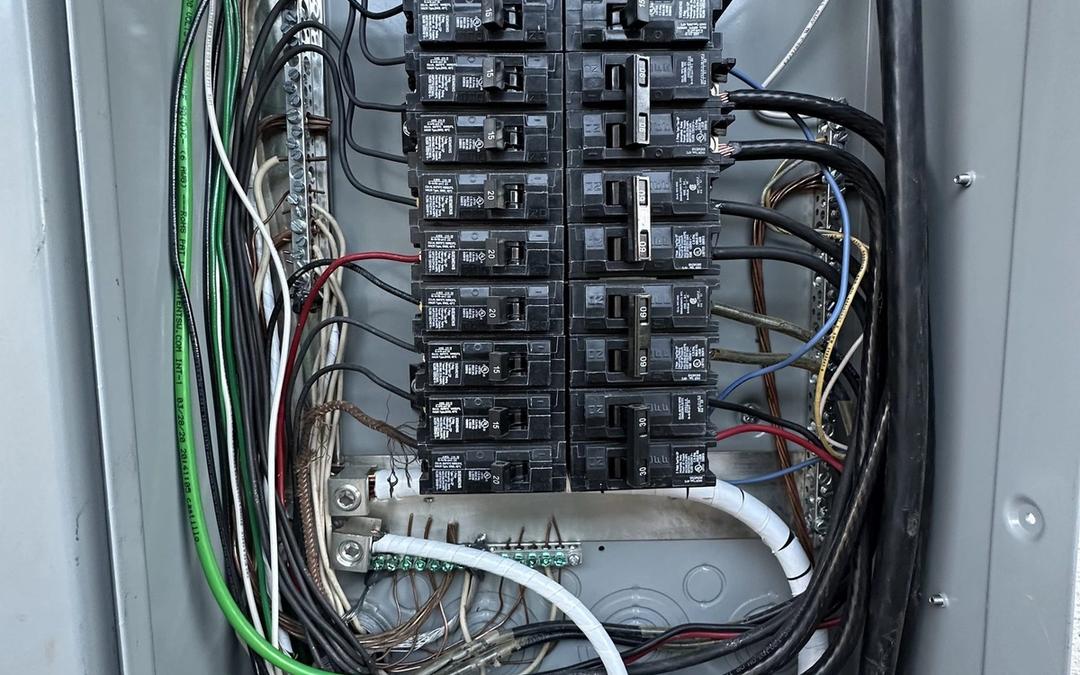 Interior of a new breaker panel with neatly routed wires