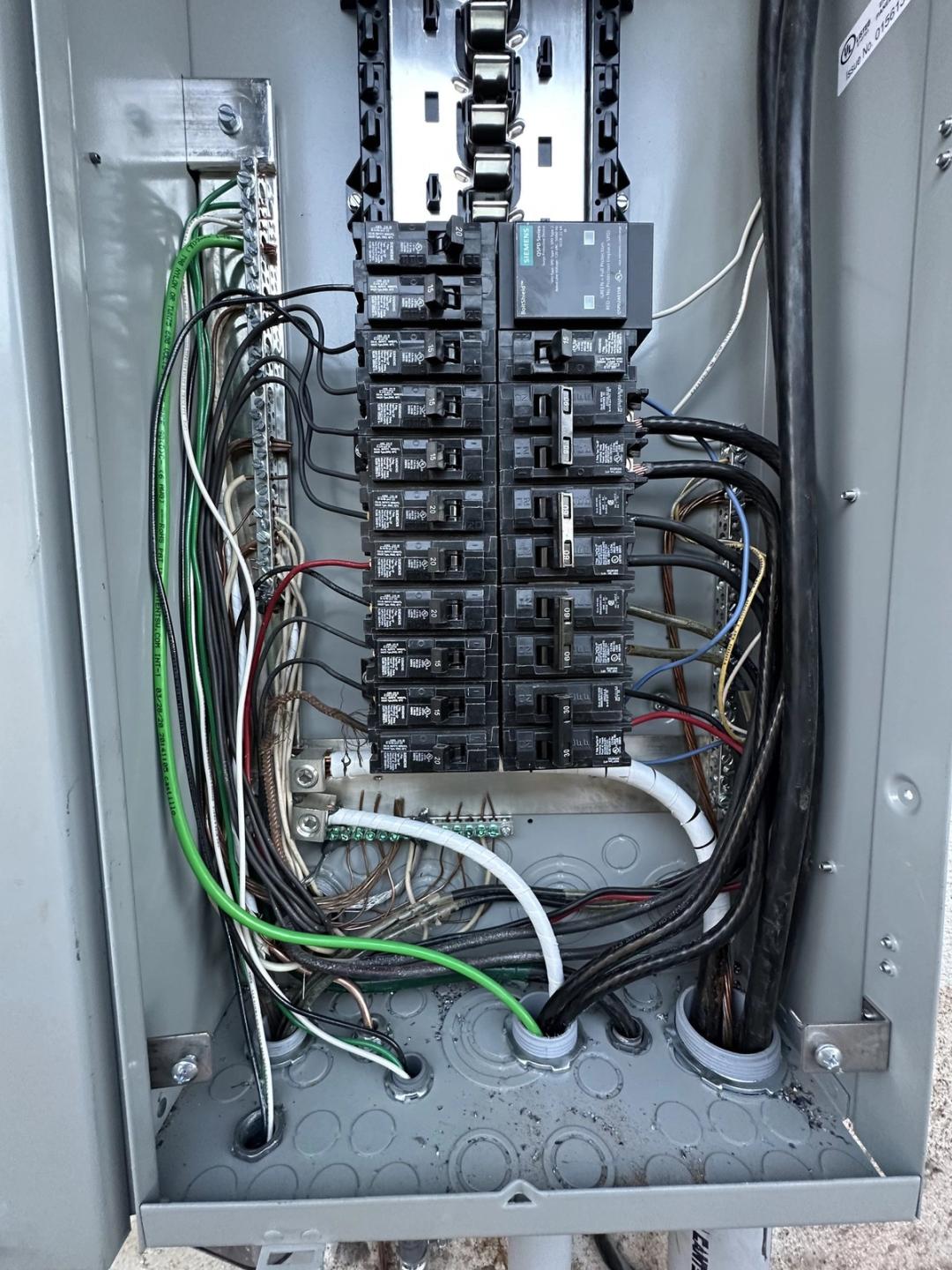 Interior of a new breaker panel with neatly routed wires