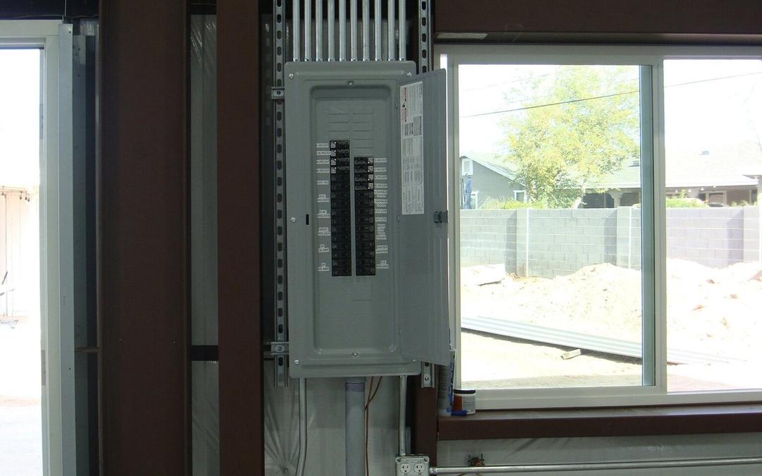 New breaker panel with a bank of conduit inside a metal building