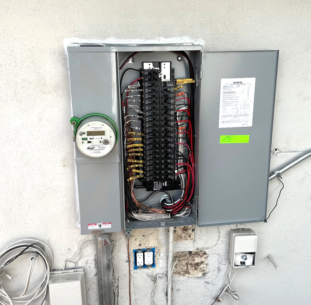 New Siemens electrical panel with labeled breakers next to an SRP meter on a stucco wall
