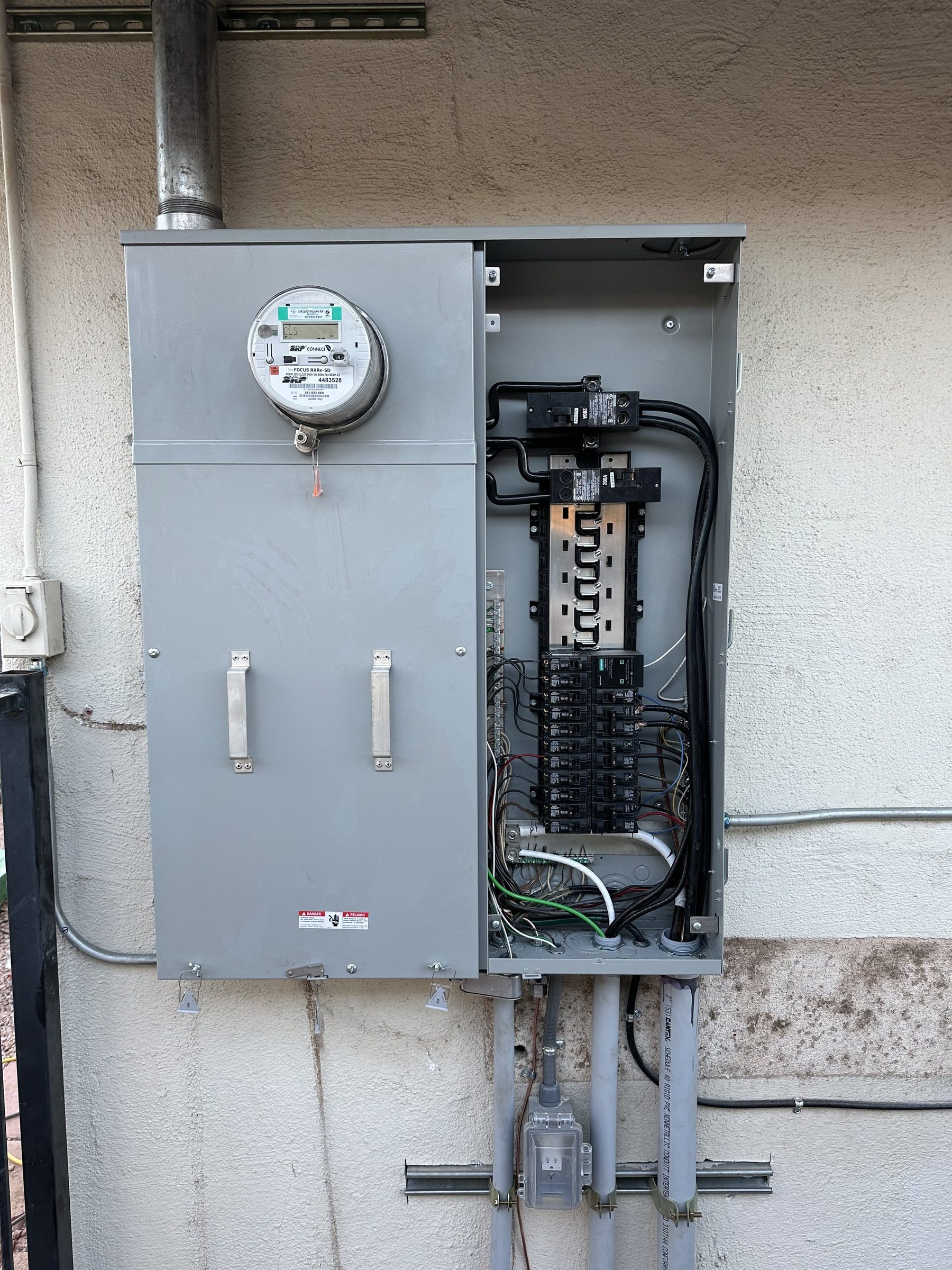 Meter-main combination panel with dead front removed showing neatly landed breakers
