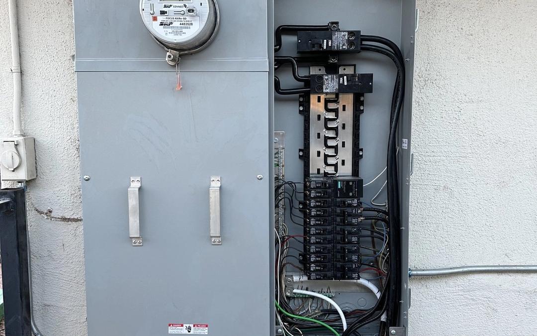 Meter-main combination panel with dead front removed showing neatly landed breakers