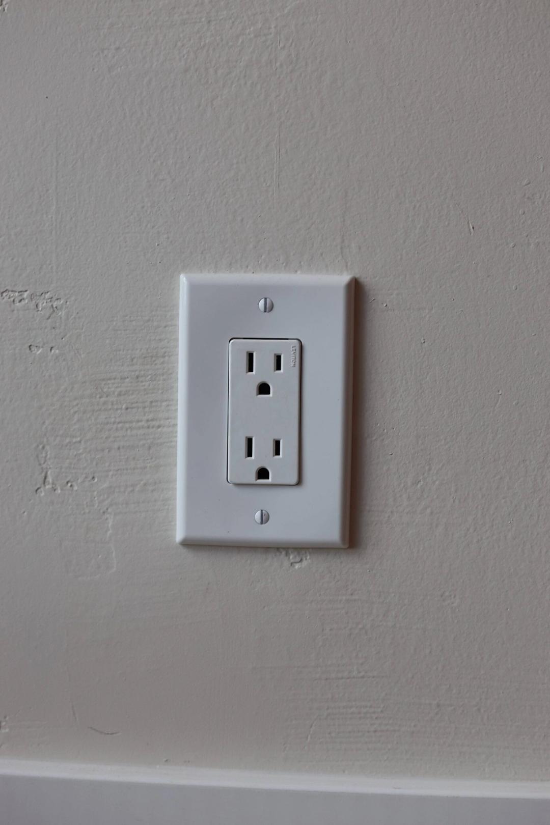 White duplex outlet on a textured wall