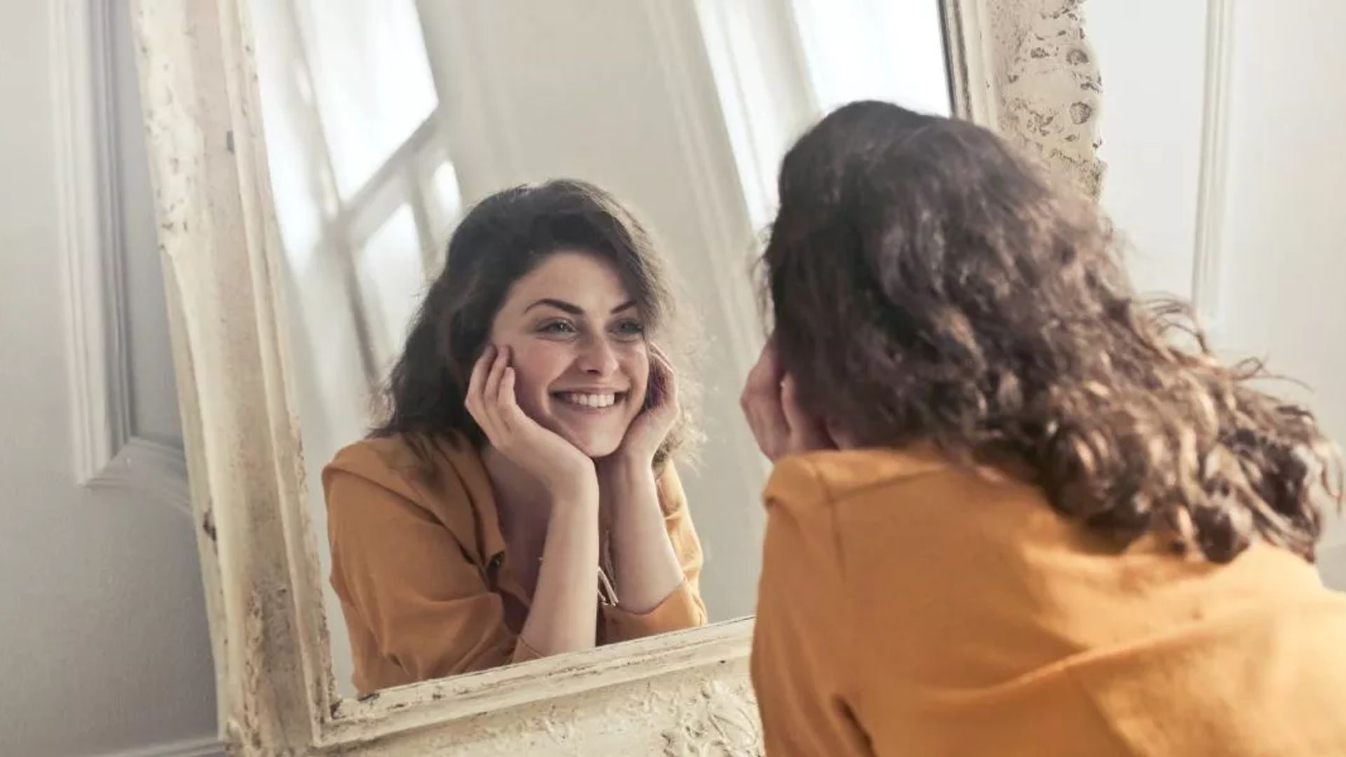 Image of person smiling in the mirror