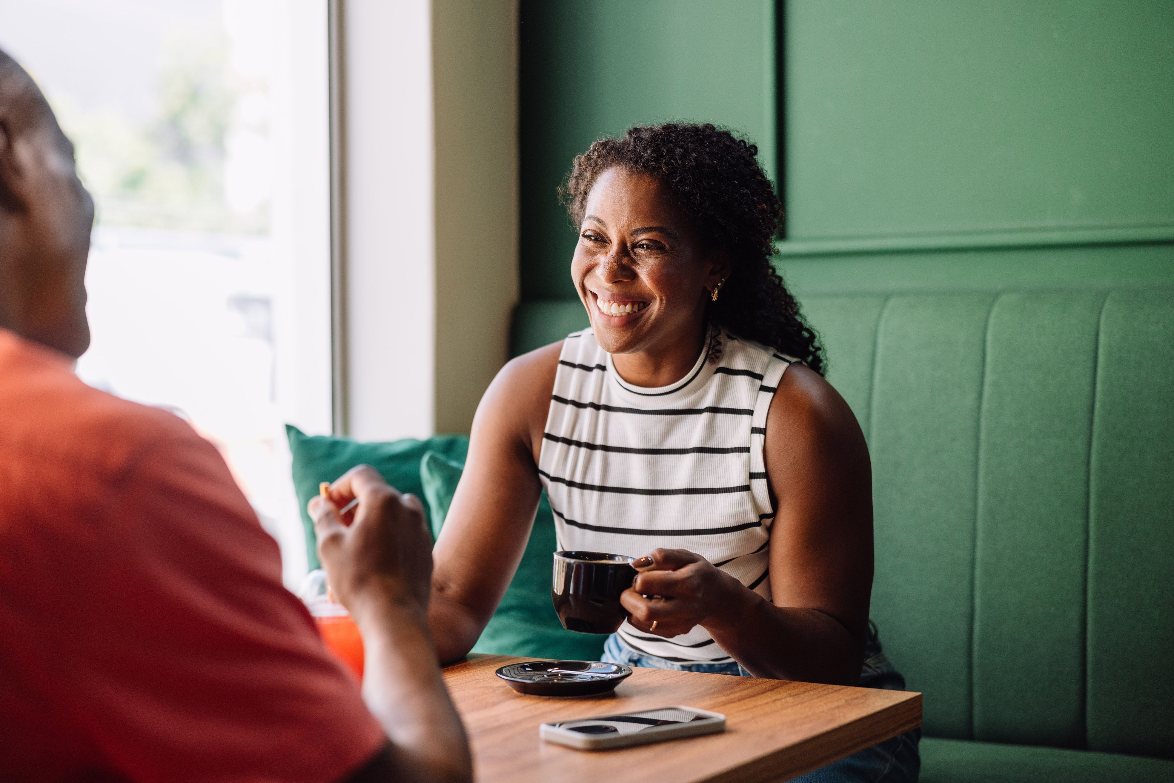image of lady drinking coffee and laughing