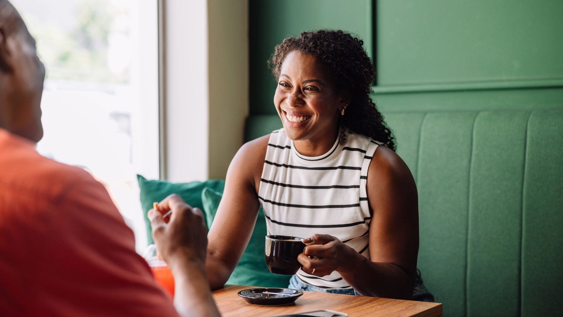 image of lady drinking coffee and laughing
