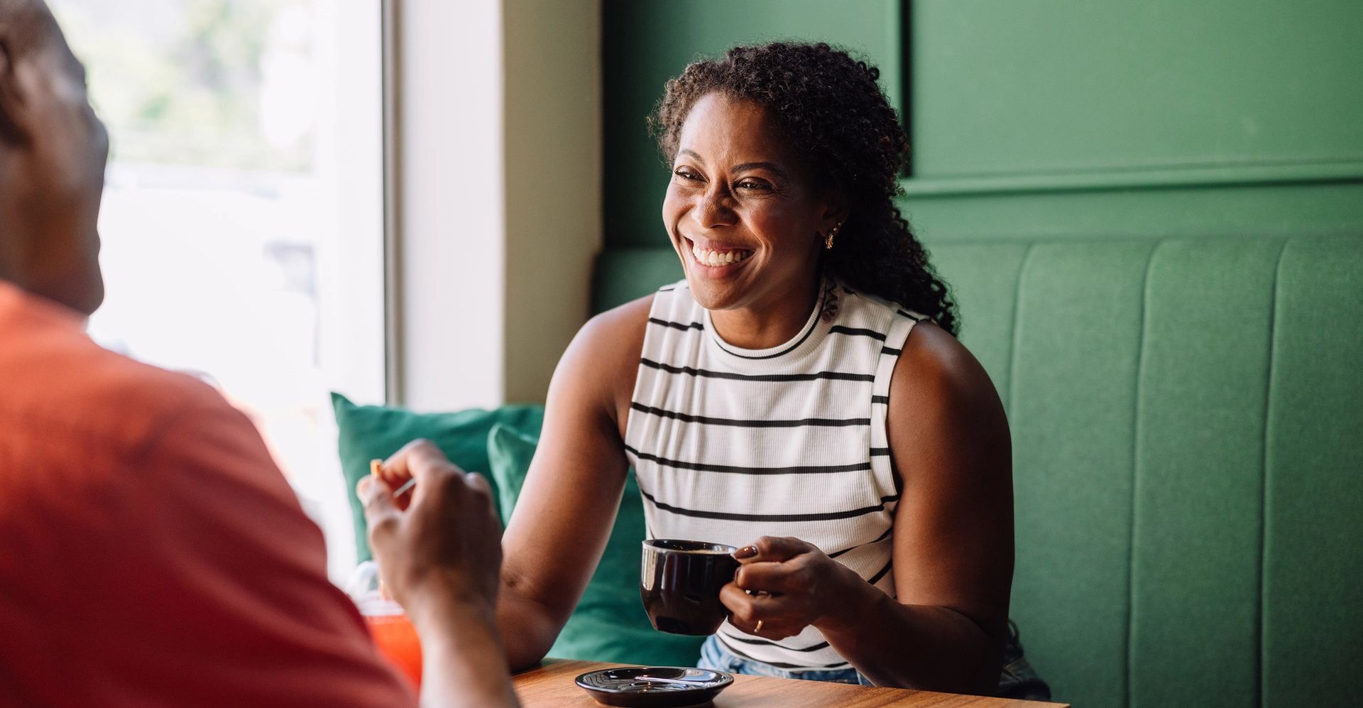 image of lady drinking coffee and laughing