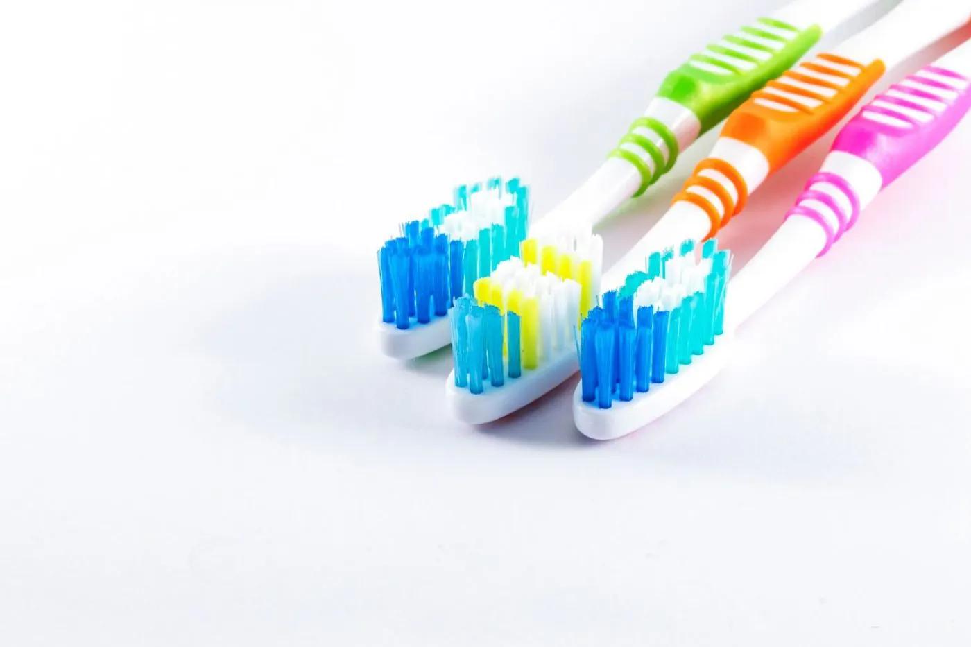 Image of three colourful toothbrushes