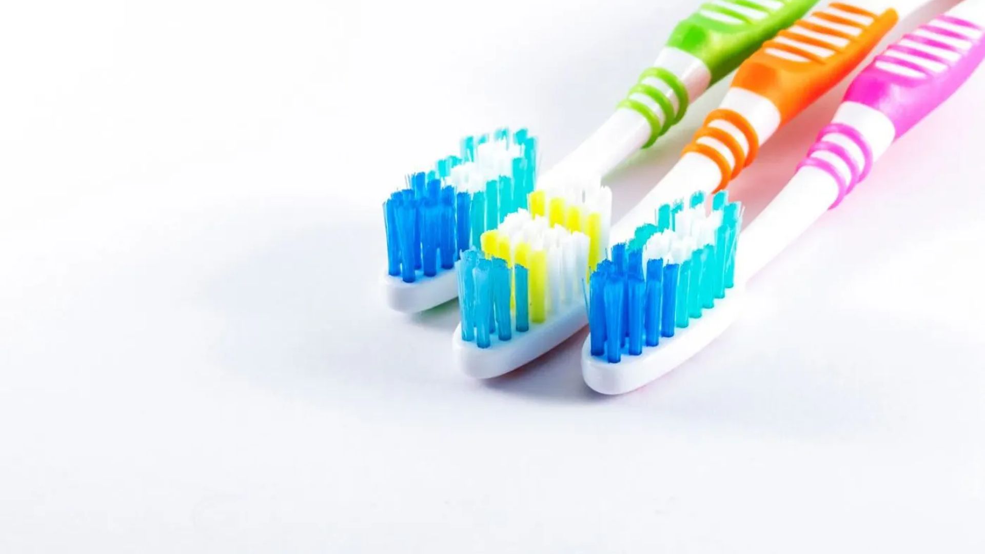 Image of three colourful toothbrushes