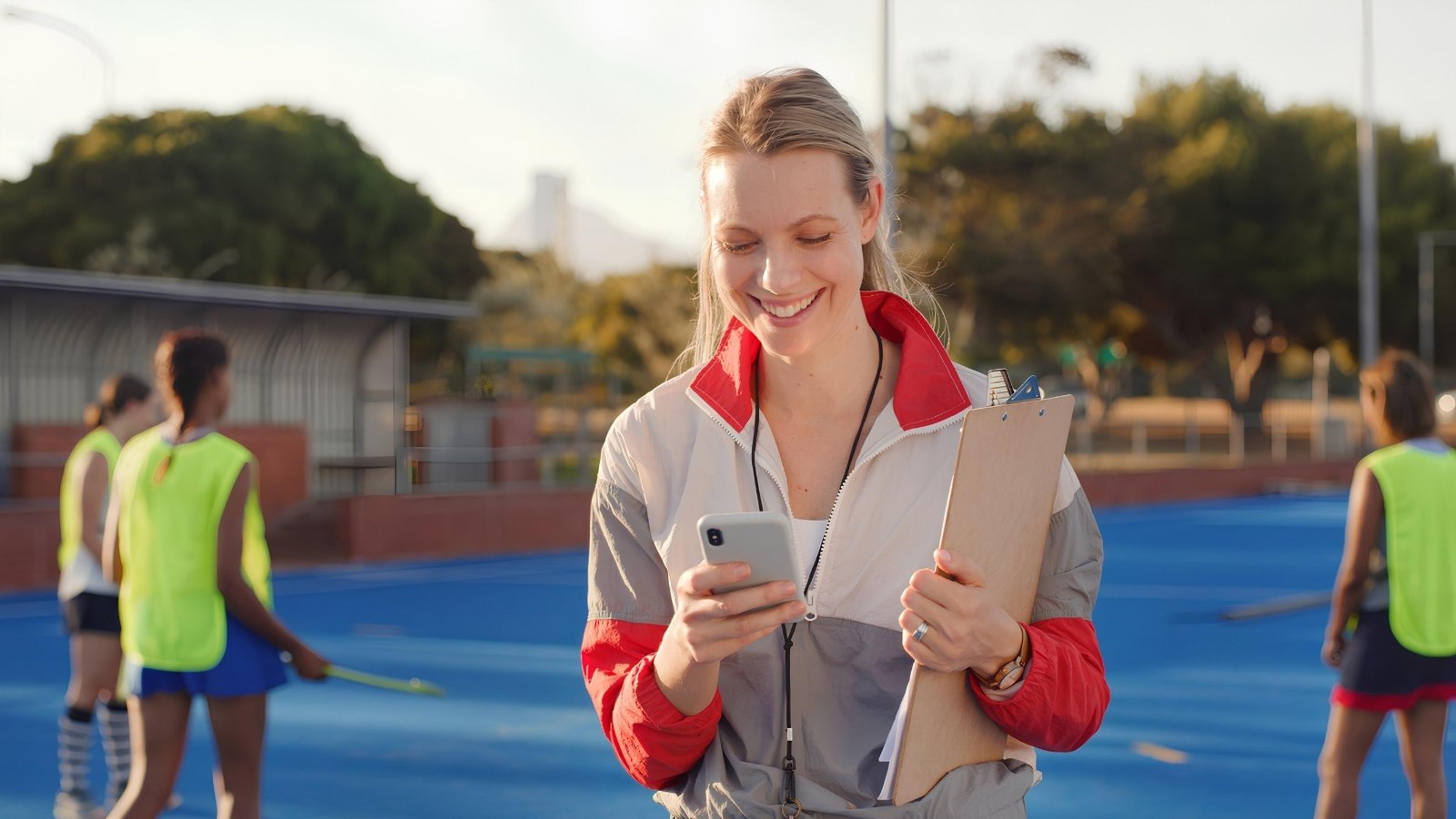 sports coach organizing on phone