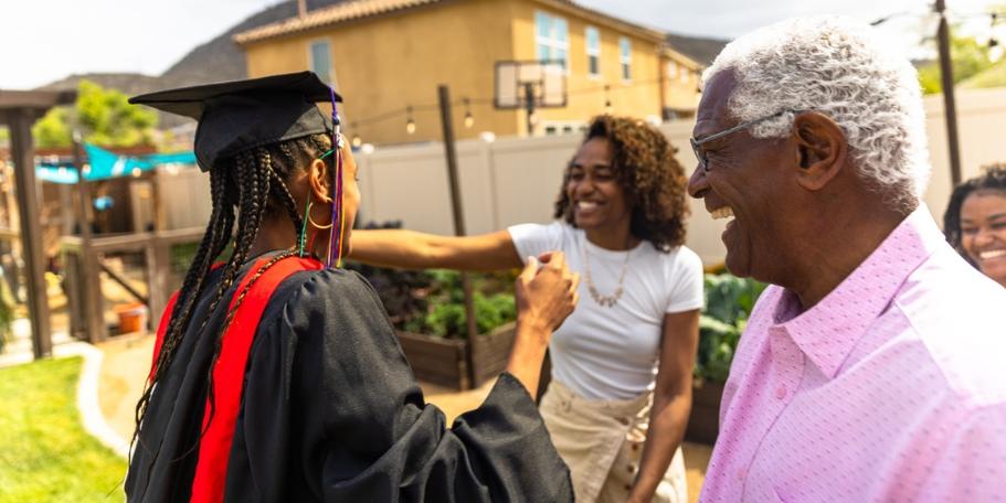 family celebrating graduation at backyard party