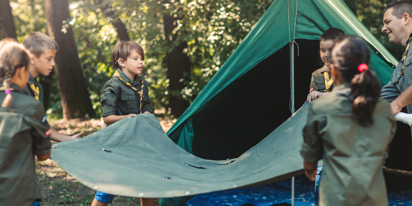 scouts building a tent