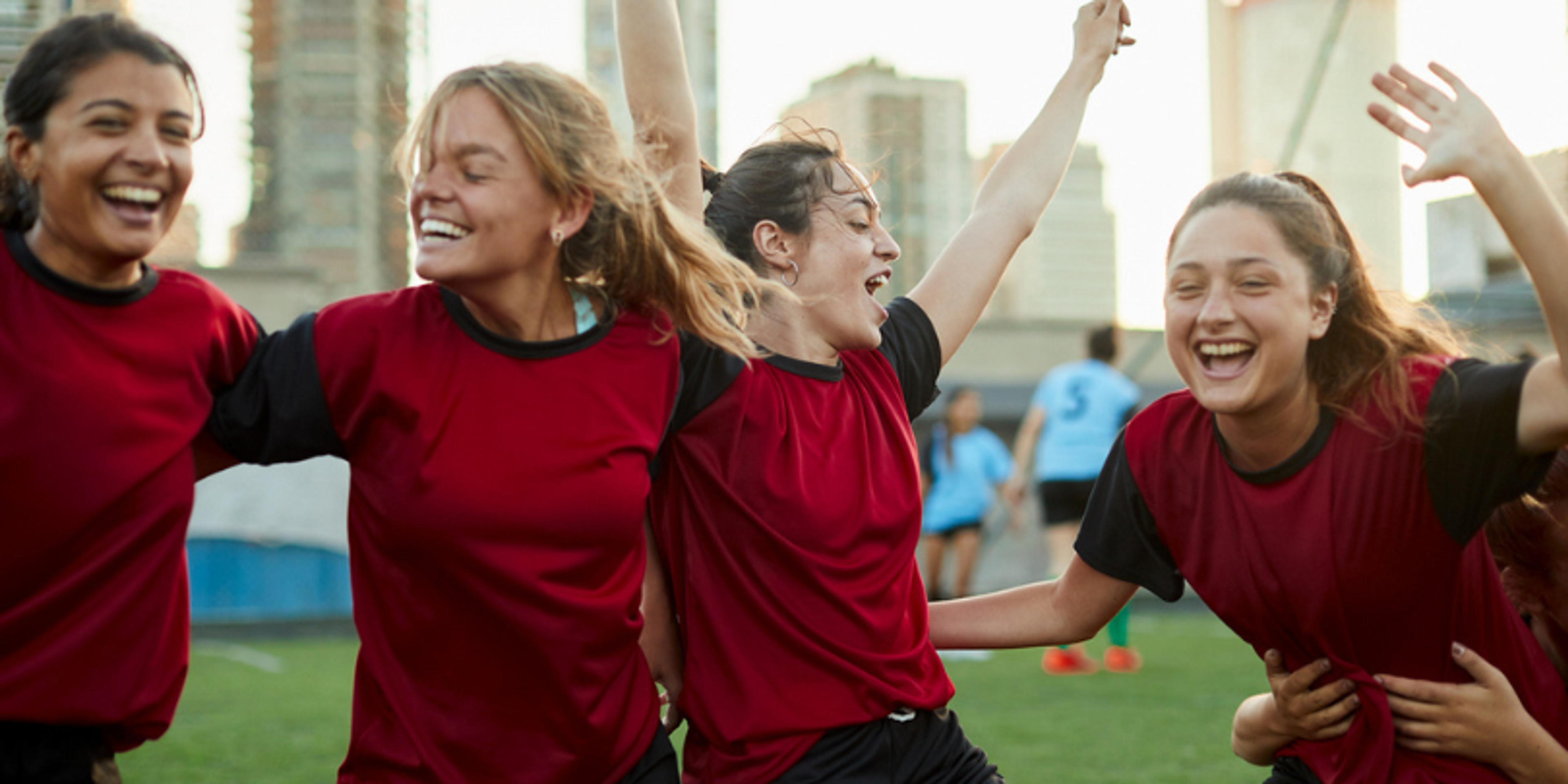 female soccer players laughing