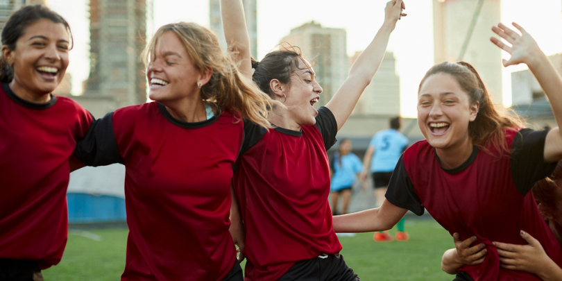 female soccer players laughing