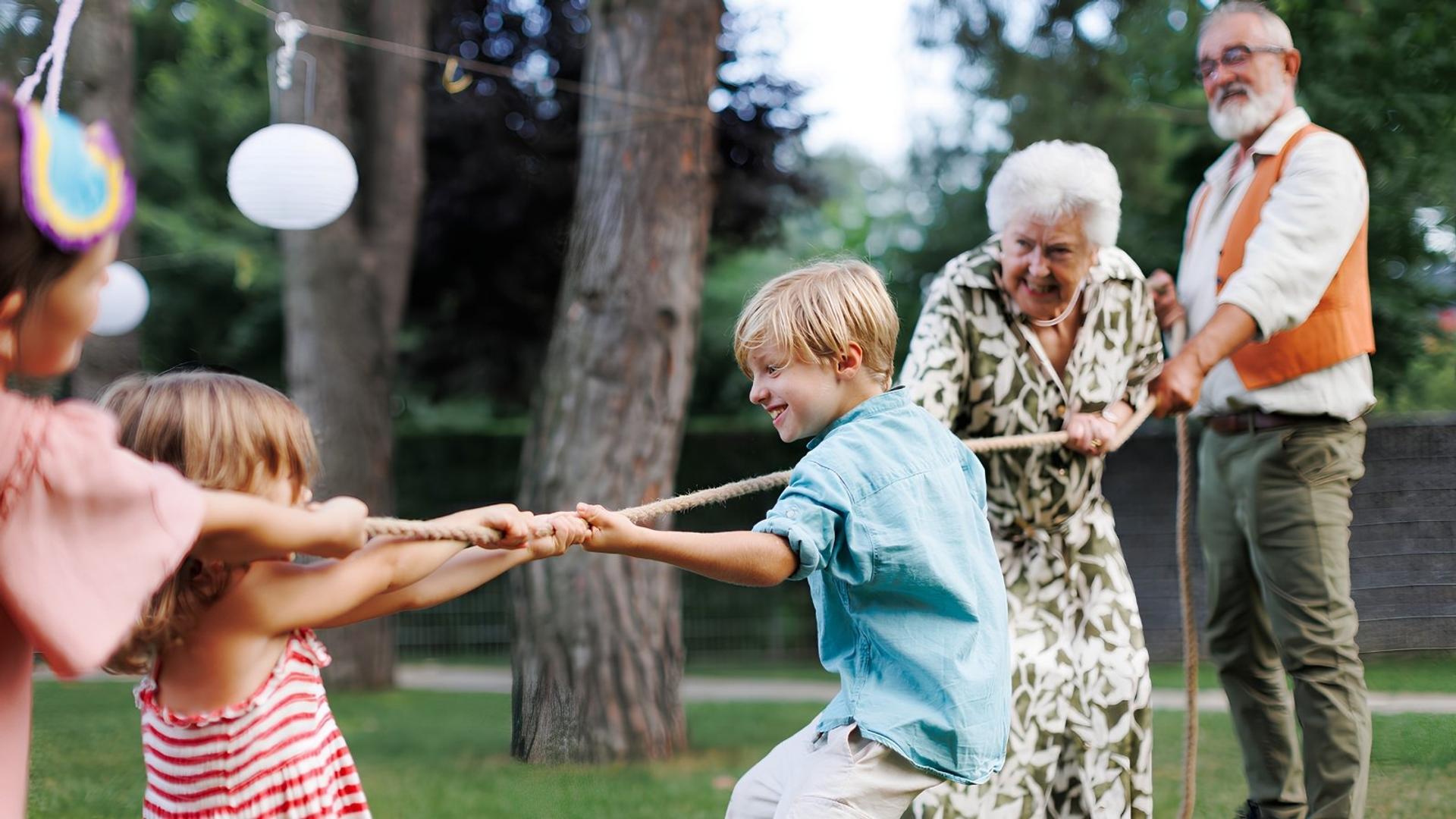 multi-generational-family-playing-tug-of-war