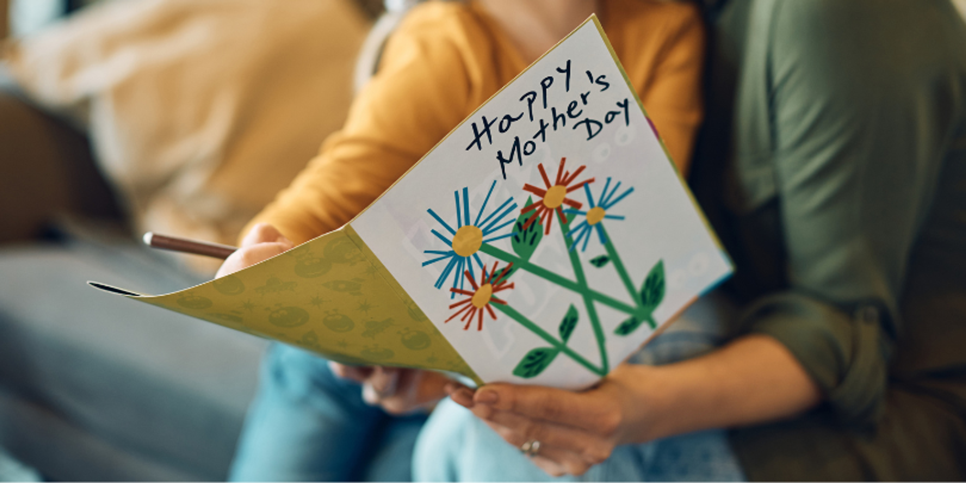 mom reading mother's day card