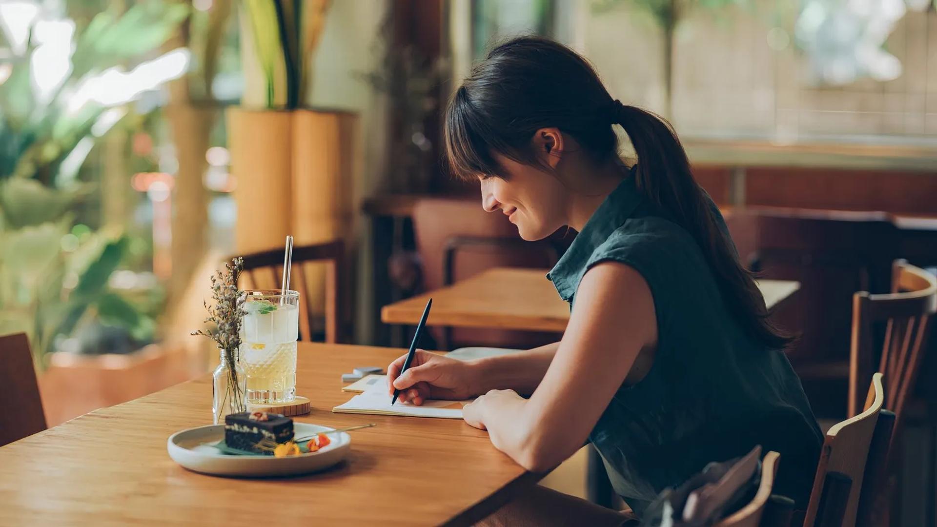 woman writing at table